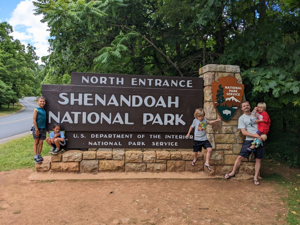 Dad + Four Boys standing at the entrance to Shenandoah National Park