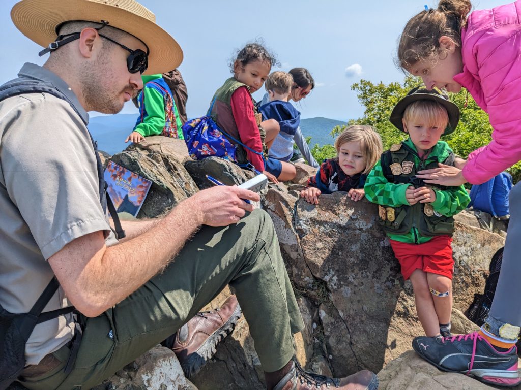 Boys pose with a Park Ranger atop Stony Man Trail