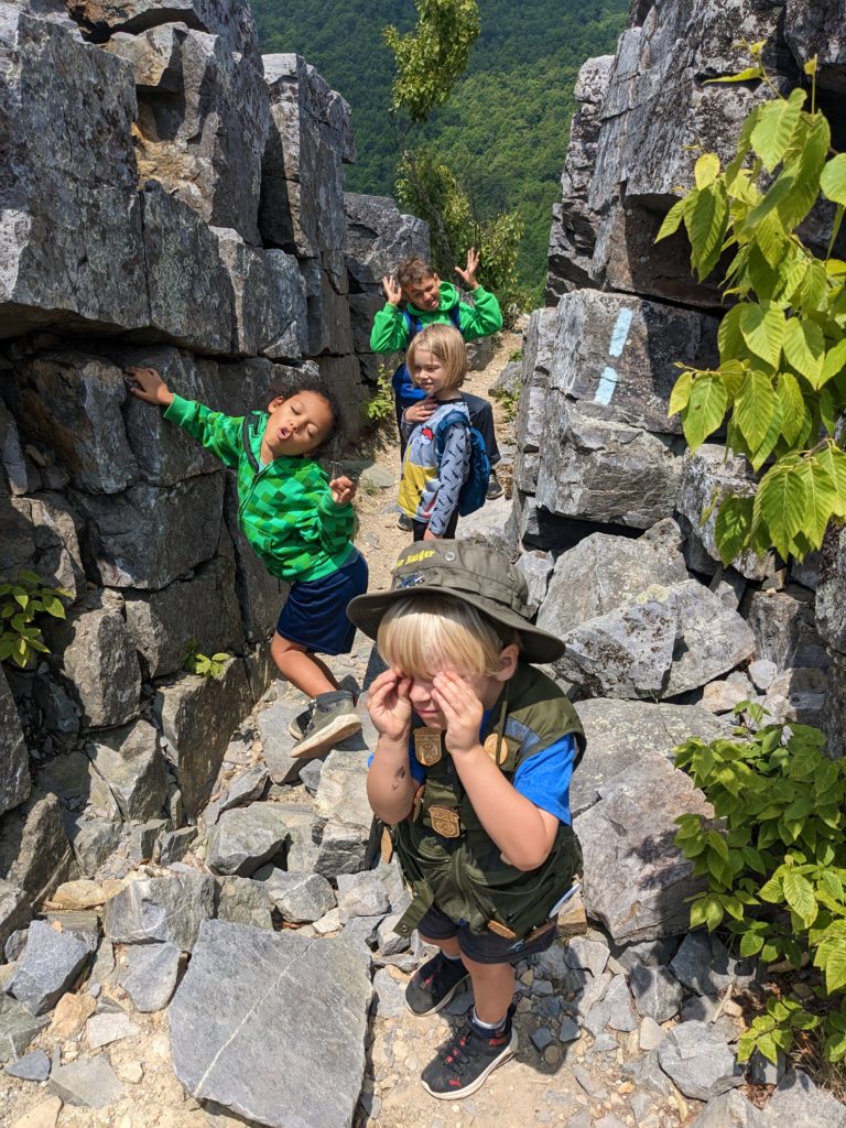 Four Kids hiking between boulders along the Blackrock Summit Trail