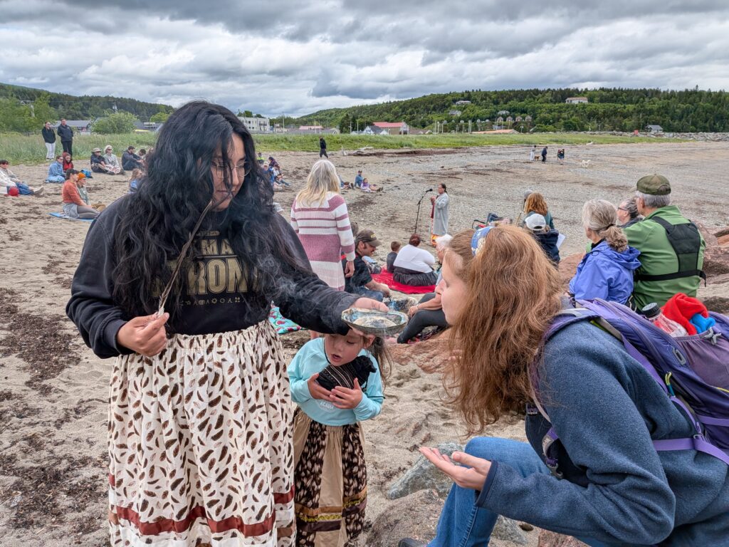 Cassy receiving her Sage Bath from the Indigenous Mi'kmaw Welcoming of the Salmon Ceremony on Summer Solstice