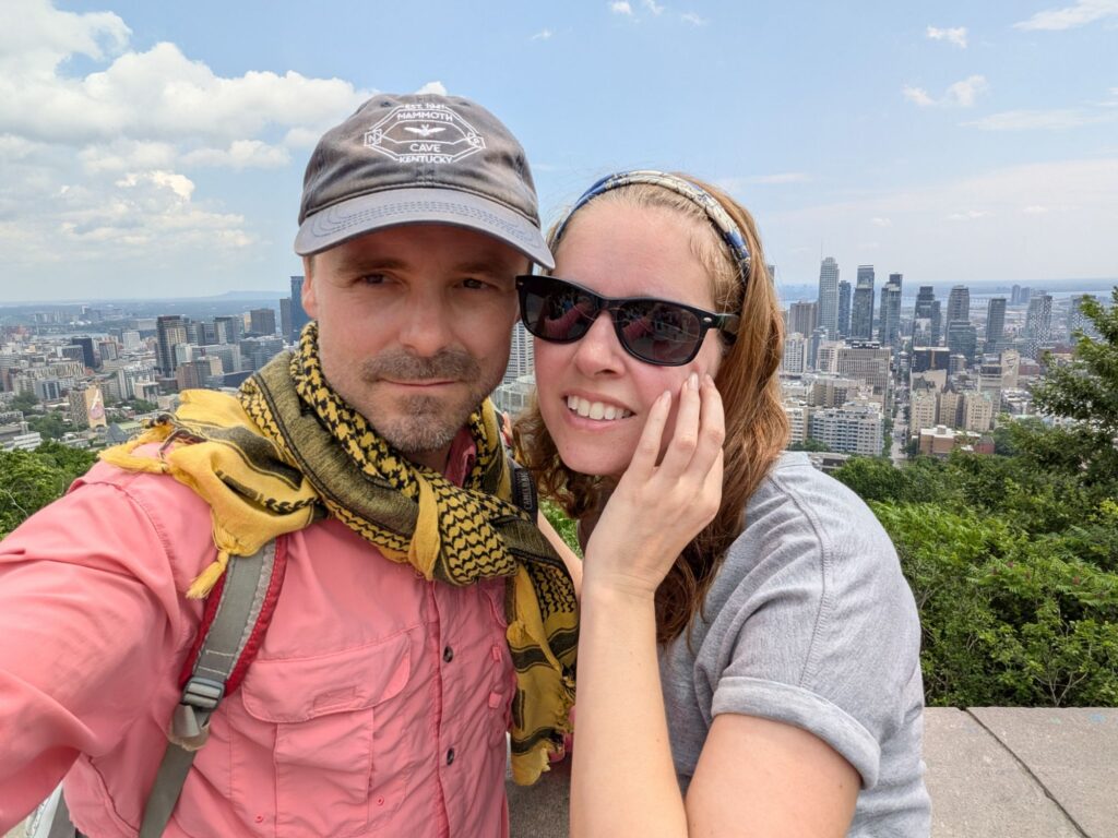 Cassy and Dad on the top of Mont Royal, with a view to the city of Montreal